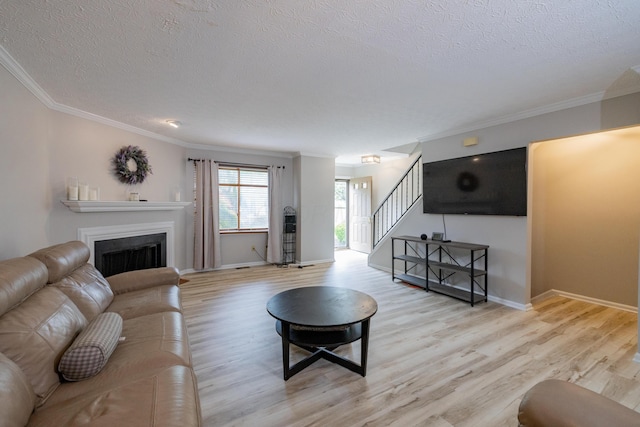 3243 Brookview Way Unit 68, Columbus, OH 43221 - living room featuring a textured ceiling, stairs, wood finished floors, crown molding, and a fireplace