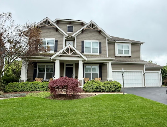 2459 Friesian Ln, Powell, OH 43065 - craftsman-style house with driveway, a front lawn, an attached garage, and a shingled roof