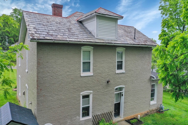 1904 Cedar Hill Rd, Lancaster, OH 43130 - rear view of house with a chimney, brick siding, a high end roof, and a lawn
