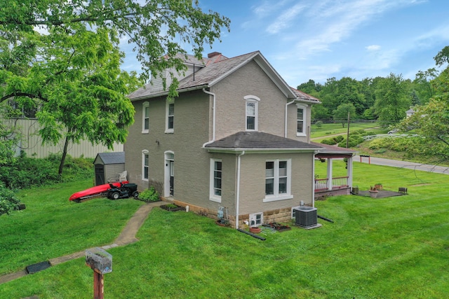 1904 Cedar Hill Rd, Lancaster, OH 43130 - view of side of home featuring central AC, a lawn, and a chimney