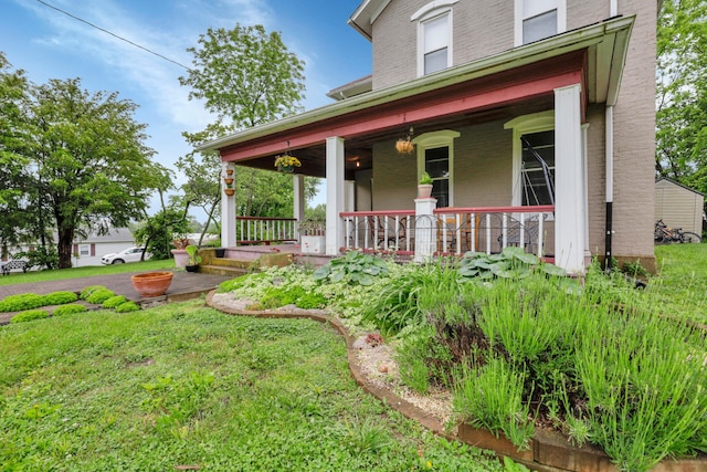 1904 Cedar Hill Rd, Lancaster, OH 43130 - view of front of house featuring a porch, brick siding, and a front yard