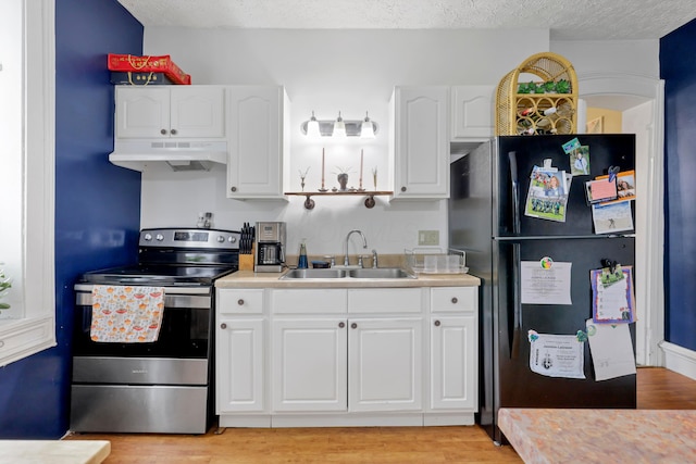 1904 Cedar Hill Rd, Lancaster, OH 43130 - kitchen with stainless steel range with electric stovetop, a sink, freestanding refrigerator, under cabinet range hood, and light countertops