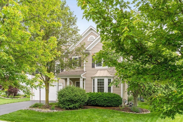 4560 Greyson Dr, Powell, OH 43065 - view of front facade featuring asphalt driveway, a front yard, and a garage