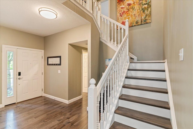 4560 Greyson Dr, Powell, OH 43065 - foyer entrance featuring wood finished floors, baseboards, and stairway