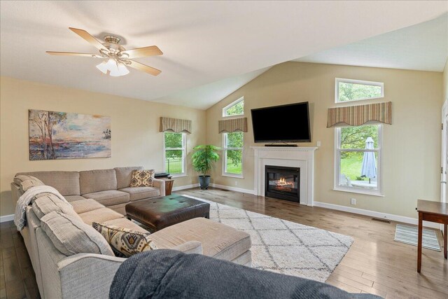 4560 Greyson Dr, Powell, OH 43065 - living room with wood finished floors, healthy amount of natural light, high vaulted ceiling, and a glass covered fireplace