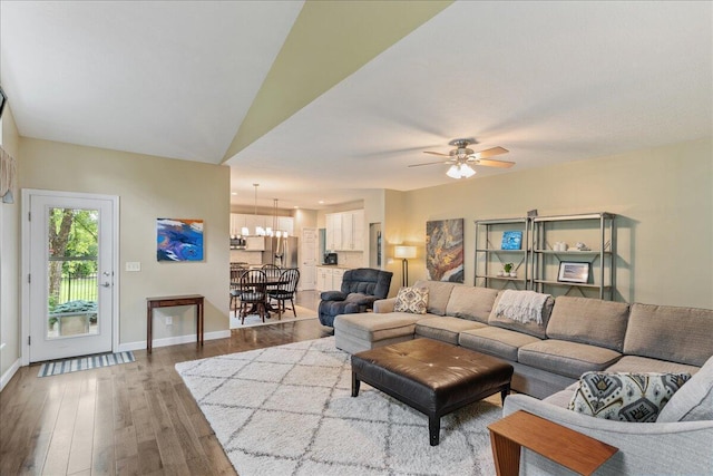 4560 Greyson Dr, Powell, OH 43065 - living area featuring wood finished floors, a chandelier, a ceiling fan, and baseboards