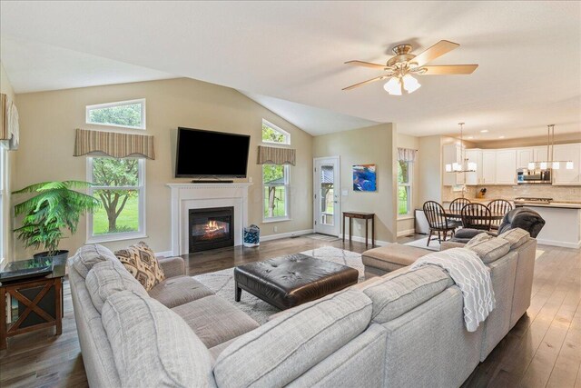 4560 Greyson Dr, Powell, OH 43065 - living area featuring ceiling fan, a chandelier, wood finished floors, healthy amount of natural light, and lofted ceiling