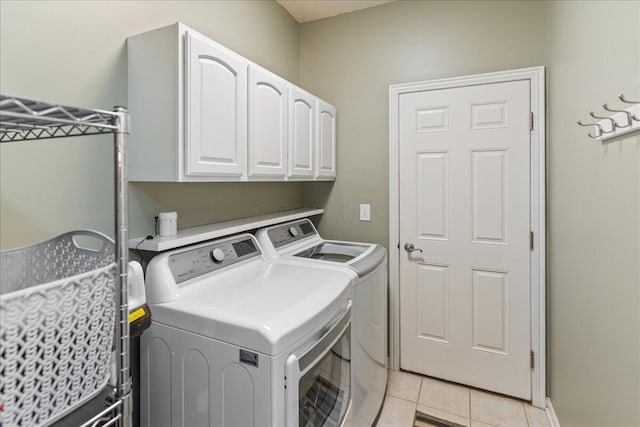 4560 Greyson Dr, Powell, OH 43065 - washroom featuring washer and dryer, cabinet space, and light tile patterned flooring