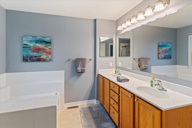 4560 Greyson Dr, Powell, OH 43065 - bathroom with double vanity, a garden tub, baseboards, and tile patterned floors