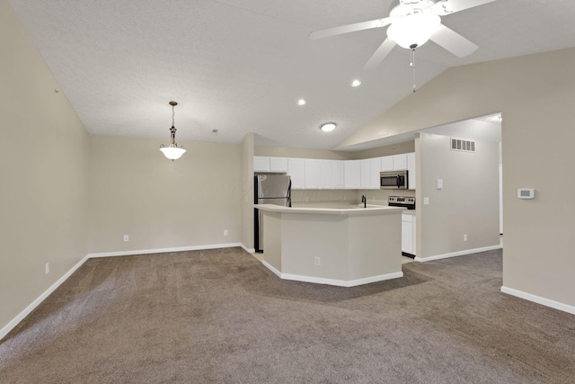 108 Shelbourne Forest Way, Delaware, OH 43015 - kitchen with appliances with stainless steel finishes, white cabinets, dark carpet, lofted ceiling, and light countertops