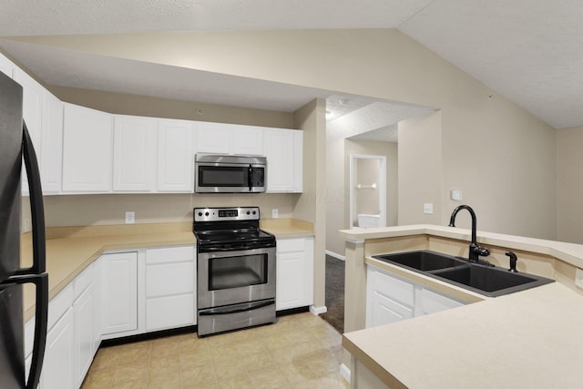 108 Shelbourne Forest Way, Delaware, OH 43015 - kitchen with appliances with stainless steel finishes, a sink, lofted ceiling, white cabinets, and light countertops