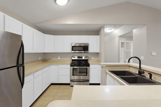 108 Shelbourne Forest Way, Delaware, OH 43015 - kitchen featuring stainless steel appliances, a sink, vaulted ceiling, white cabinets, and light countertops