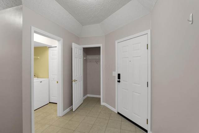 108 Shelbourne Forest Way, Delaware, OH 43015 - hallway featuring light tile patterned floors, washer / clothes dryer, baseboards, and a textured ceiling