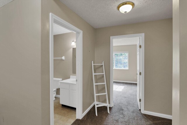108 Shelbourne Forest Way, Delaware, OH 43015 - hallway with a textured ceiling, baseboards, and carpet flooring