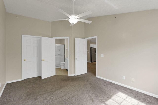 108 Shelbourne Forest Way, Delaware, OH 43015 - unfurnished bedroom with freestanding refrigerator, carpet, baseboards, connected bathroom, and vaulted ceiling
