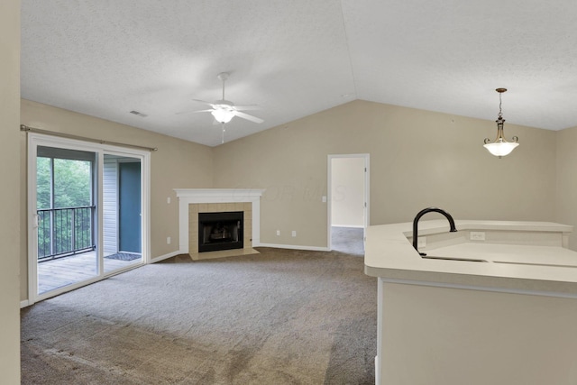 108 Shelbourne Forest Way, Delaware, OH 43015 - unfurnished living room featuring a sink, carpet, ceiling fan, lofted ceiling, and a tiled fireplace
