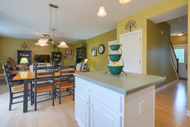 6612 Archie Ct, Canal Winchester, OH 43110 - kitchen with light wood finished floors, a center island, white cabinetry, and pendant lighting
