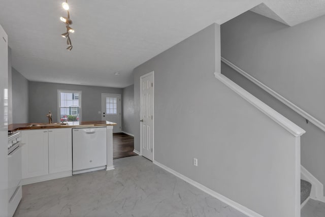 6022 Brice Park Dr Unit 17D, Canal Winchester, OH 43110 - kitchen featuring dishwasher, a sink, white cabinetry, light marble finish flooring, and wood counters