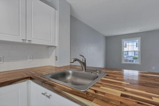 6022 Brice Park Dr Unit 17D, Canal Winchester, OH 43110 - kitchen with wooden counters, a sink, backsplash, and white cabinets