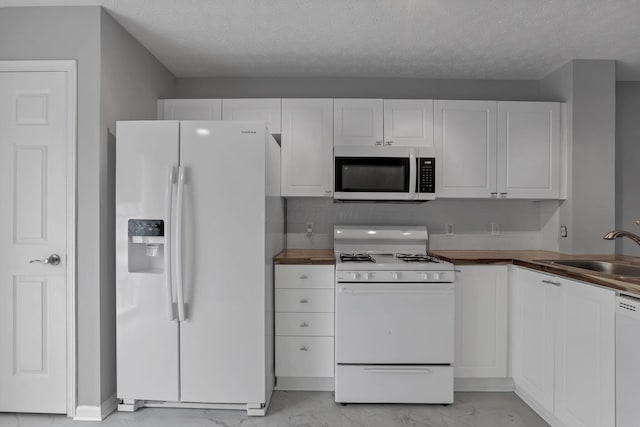 6022 Brice Park Dr Unit 17D, Canal Winchester, OH 43110 - kitchen with white appliances, a sink, butcher block counters, light marble finish floors, and white cabinetry