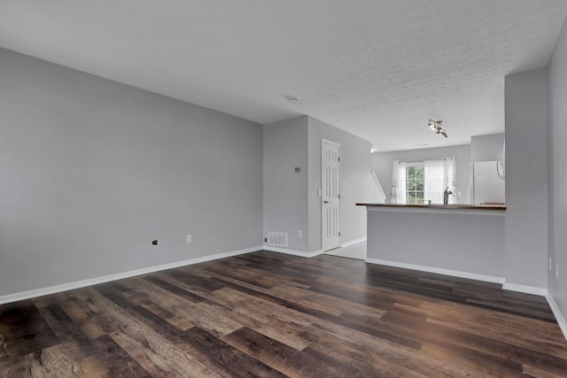 6022 Brice Park Dr Unit 17D, Canal Winchester, OH 43110 - unfurnished living room with dark wood-style floors, baseboards, and a textured ceiling