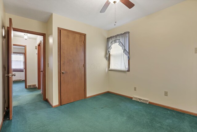 907 Fairfield Ave, Lancaster, OH 43130 - unfurnished bedroom featuring multiple windows, carpet floors, baseboards, and a closet