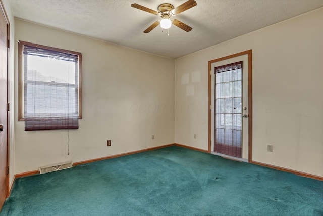 907 Fairfield Ave, Lancaster, OH 43130 - carpeted empty room featuring plenty of natural light, ceiling fan, baseboards, and a textured ceiling