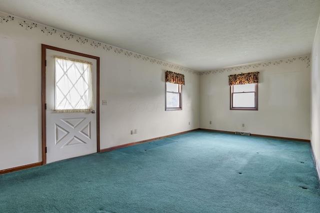 907 Fairfield Ave, Lancaster, OH 43130 - empty room with a textured ceiling, carpet flooring, and baseboards