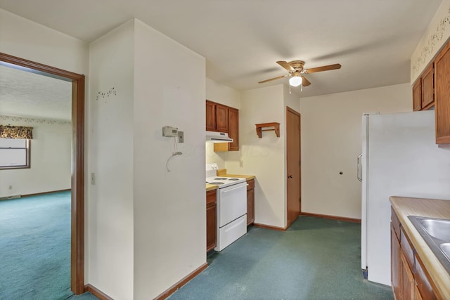 907 Fairfield Ave, Lancaster, OH 43130 - kitchen featuring white appliances, under cabinet range hood, dark carpet, ceiling fan, and brown cabinetry