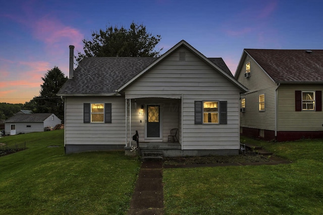 907 Fairfield Ave, Lancaster, OH 43130 - bungalow featuring a yard, roof with shingles, and covered porch