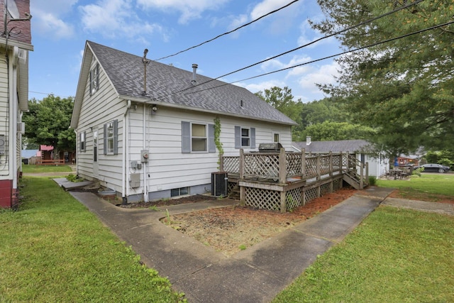 907 Fairfield Ave, Lancaster, OH 43130 - rear view of house featuring a shingled roof, a wooden deck, a lawn, and cooling unit