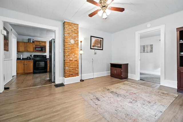 101 Meadow Ln, Gambier, OH 43022 - unfurnished living room featuring a ceiling fan and light wood finished floors