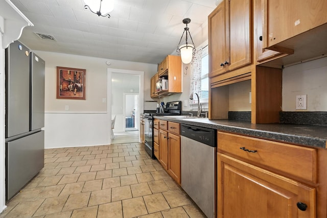 101 Meadow Ln, Gambier, OH 43022 - kitchen featuring black appliances, dark countertops, brown cabinetry, decorative light fixtures, and light tile patterned flooring