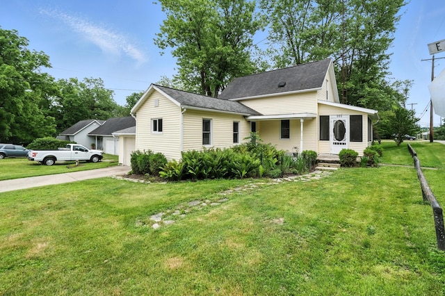 101 Meadow Ln, Gambier, OH 43022 - view of front of house with a garage, a front lawn, roof with shingles, and concrete driveway