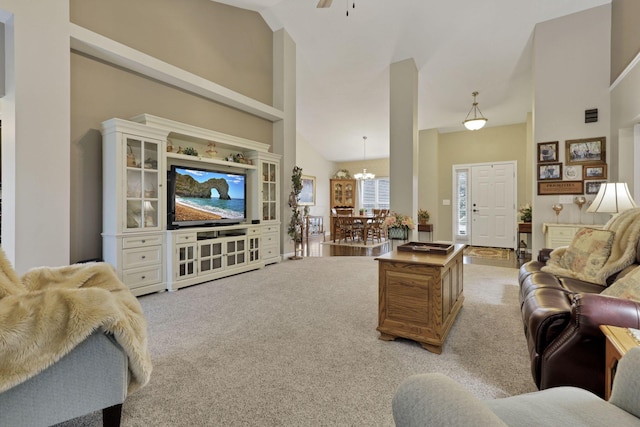 217 Warbler Ct, Pickerington, OH 43147 - living area with light colored carpet, high vaulted ceiling, a chandelier, and a ceiling fan