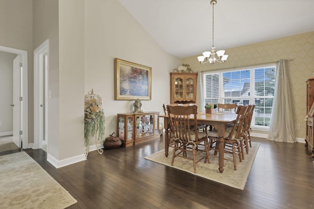 217 Warbler Ct, Pickerington, OH 43147 - dining area with baseboards, a chandelier, wallpapered walls, dark wood-style floors, and high vaulted ceiling