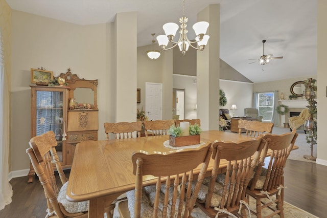 217 Warbler Ct, Pickerington, OH 43147 - dining space with dark wood finished floors, ceiling fan, a chandelier, high vaulted ceiling, and baseboards