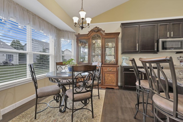 217 Warbler Ct, Pickerington, OH 43147 - dining space featuring lofted ceiling, a chandelier, dark wood-style flooring, and baseboards