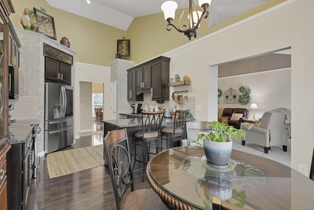217 Warbler Ct, Pickerington, OH 43147 - dining room featuring dark wood-type flooring, a chandelier, and high vaulted ceiling