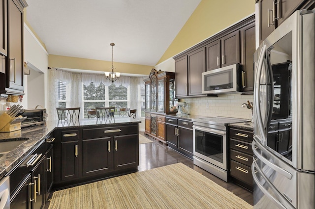 217 Warbler Ct, Pickerington, OH 43147 - kitchen with stainless steel appliances, vaulted ceiling, a chandelier, decorative backsplash, and plenty of natural light