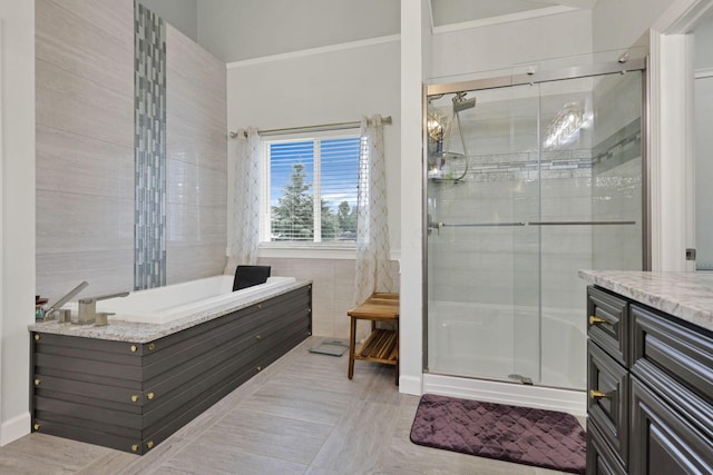 217 Warbler Ct, Pickerington, OH 43147 - full bath featuring a stall shower, a garden tub, vanity, crown molding, and tile walls