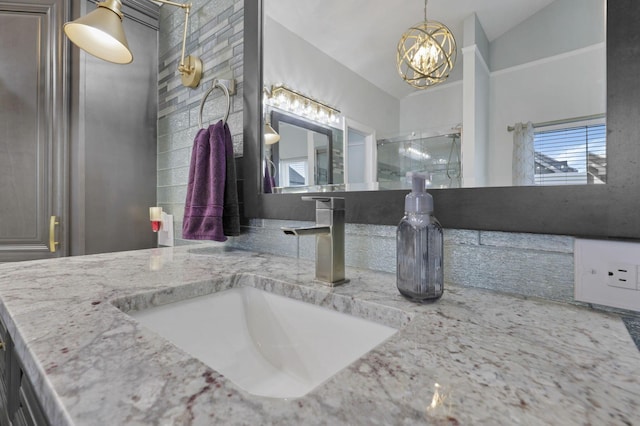 217 Warbler Ct, Pickerington, OH 43147 - full bathroom with a chandelier, double vanity, and a shower with shower door