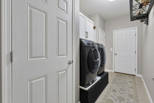 217 Warbler Ct, Pickerington, OH 43147 - laundry room with washing machine and clothes dryer, baseboards, and cabinet space