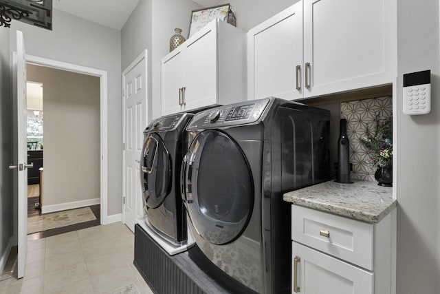 217 Warbler Ct, Pickerington, OH 43147 - washroom with separate washer and dryer, cabinet space, light tile patterned floors, and baseboards