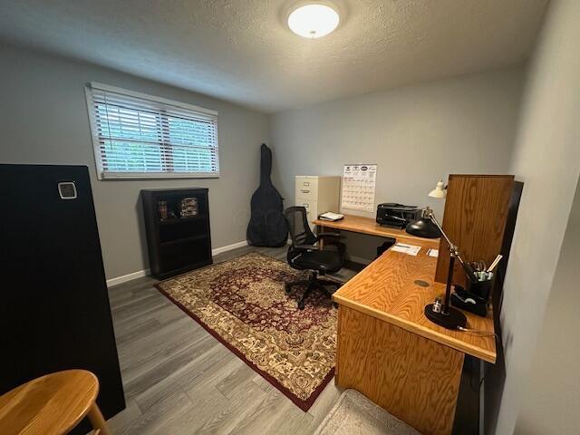 14629 Hock Hocking Rd, Logan, OH 43138 - office with wood finished floors, a textured ceiling, and baseboards