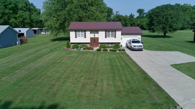 14629 Hock Hocking Rd, Logan, OH 43138 - raised ranch with a front lawn, concrete driveway, a garage, and a metal roof
