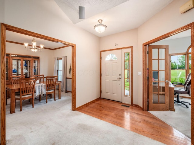 1397 Horseshoe Rd, Delaware, OH 43015 - entrance foyer featuring healthy amount of natural light, a chandelier, carpet flooring, and wood finished floors