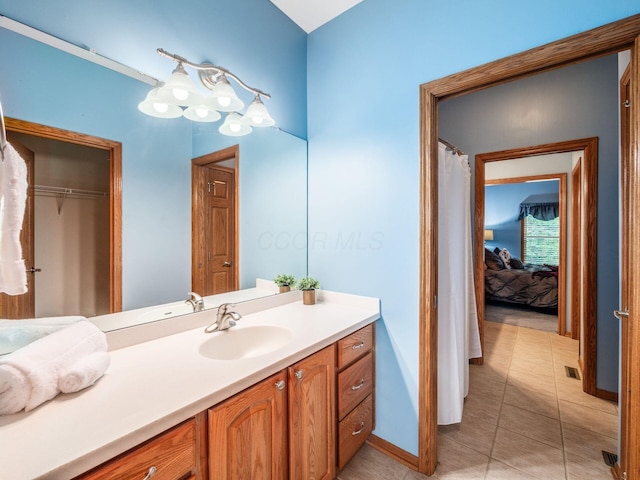 1397 Horseshoe Rd, Delaware, OH 43015 - bathroom featuring vanity, baseboards, tile patterned floors, and a closet