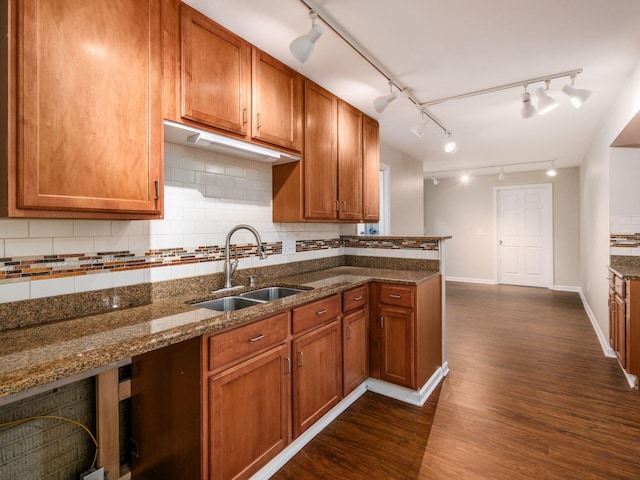 1397 Horseshoe Rd, Delaware, OH 43015 - kitchen with a sink, decorative backsplash, dark wood finished floors, dark stone countertops, and brown cabinets