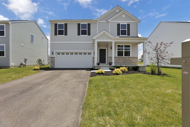 211 Whitetail Trl, Johnstown, OH 43031 - view of front of house with stone siding, a garage, driveway, and a front lawn